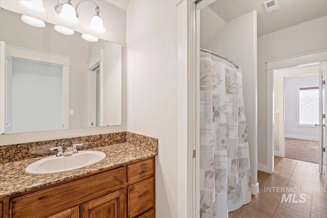 11871 W Wilmont St, Boise, ID 83709 - full bathroom with vanity, baseboards, and a shower with curtain