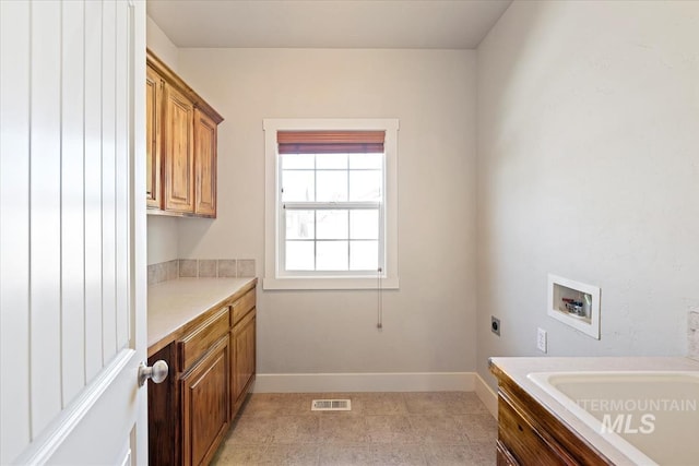 11871 W Wilmont St, Boise, ID 83709 - laundry room with hookup for a washing machine, cabinet space, hookup for an electric dryer, baseboards, and light tile patterned floors