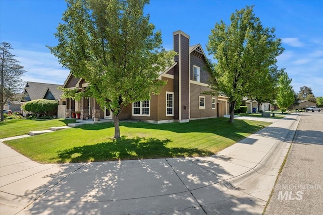 11871 W Wilmont St, Boise, ID 83709 - view of property hidden behind natural elements featuring a garage, a front yard, a chimney, and driveway