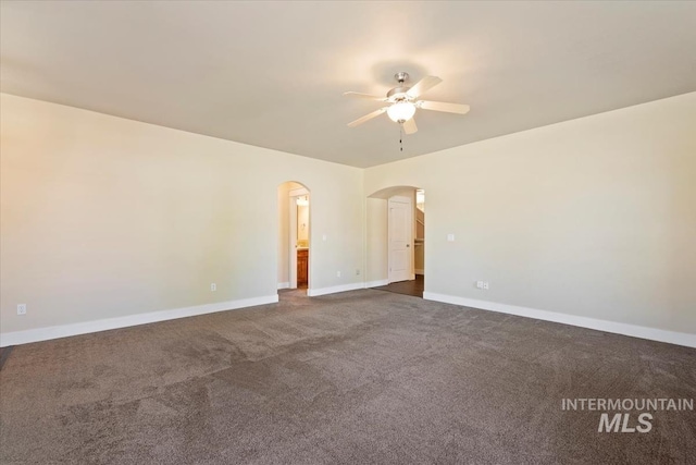 11871 W Wilmont St, Boise, ID 83709 - spare room with a ceiling fan, arched walkways, baseboards, and dark colored carpet