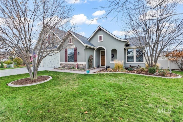 view of front of home with a front yard and a garage