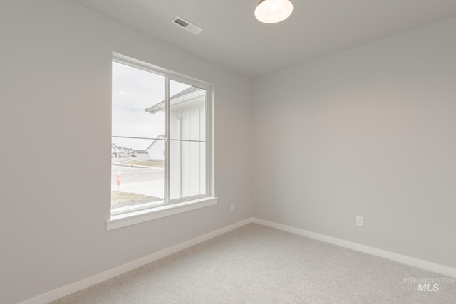 carpeted empty room featuring plenty of natural light