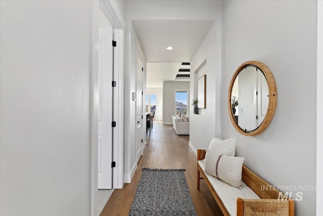 hallway featuring recessed lighting, baseboards, and wood finished floors