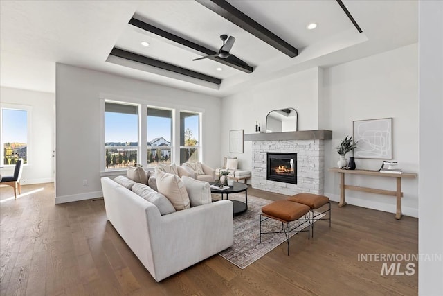 living room featuring a ceiling fan, wood finished floors, and baseboards