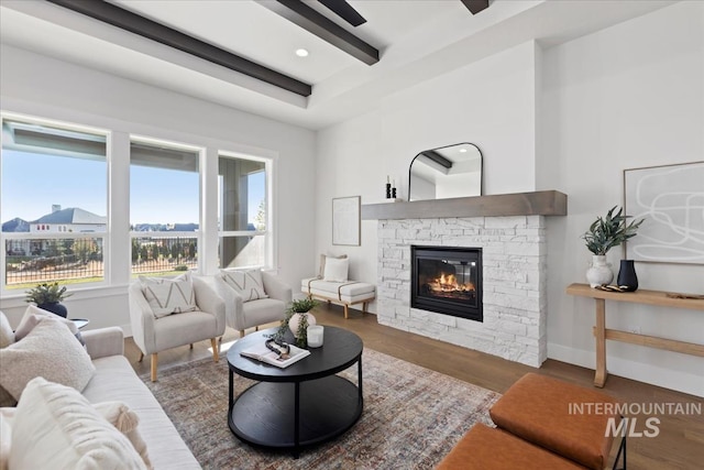 living room with baseboards, beamed ceiling, recessed lighting, a fireplace, and wood finished floors