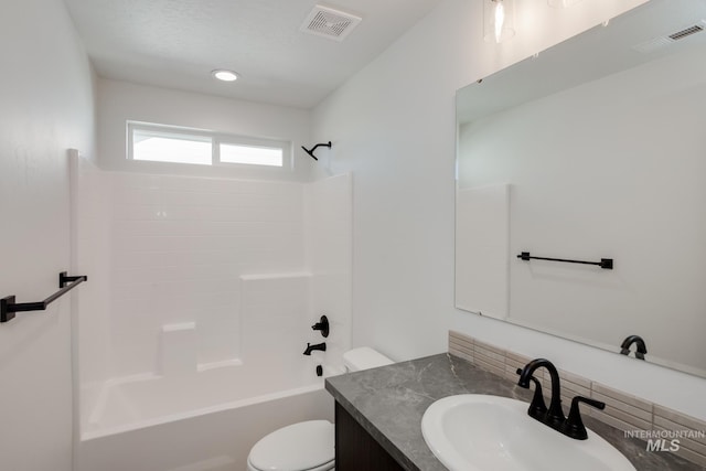 full bathroom with vanity, toilet, visible vents, and shower / bath combination