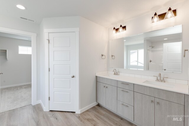 5375 S Memory Pl, Meridian, ID 83642 - full bathroom with double vanity, wood finished floors, plenty of natural light, baseboards, and recessed lighting