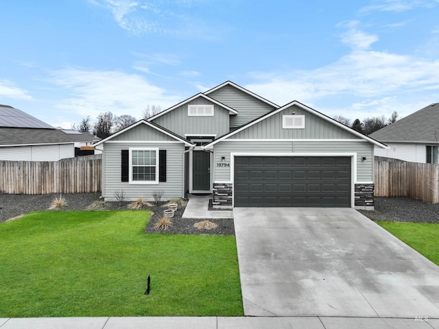 view of front of home with fence, a front lawn, concrete driveway, a garage, and board and batten siding