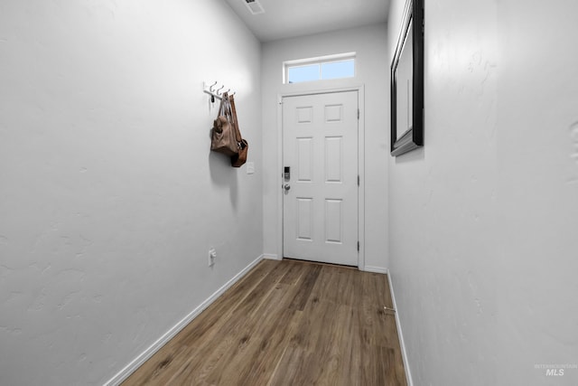 entryway with baseboards and wood finished floors