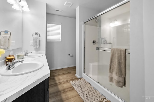 bathroom featuring a sink, visible vents, and a shower stall