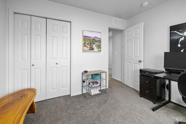 carpeted home office featuring visible vents and baseboards