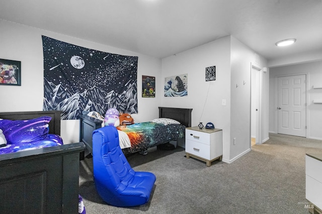 carpeted bedroom featuring baseboards