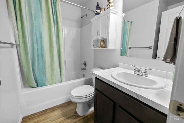 full bathroom with shower / bathtub combination with curtain, toilet, wood finished floors, and vanity