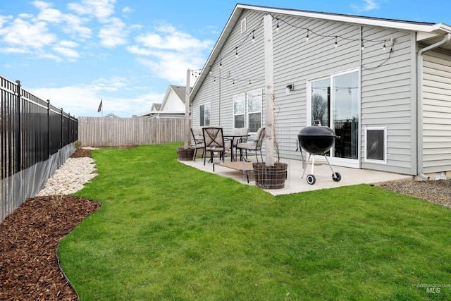 rear view of house featuring a patio, a fenced backyard, and a lawn