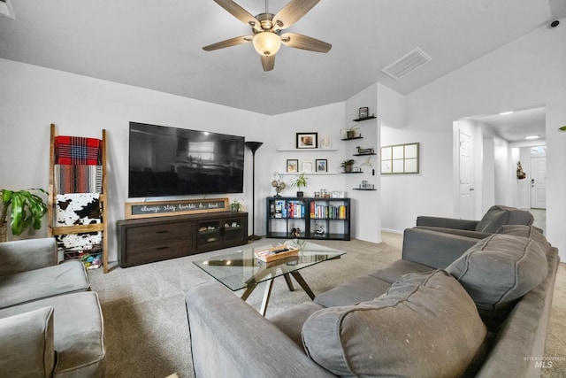 living area featuring visible vents, carpet flooring, ceiling fan, and vaulted ceiling