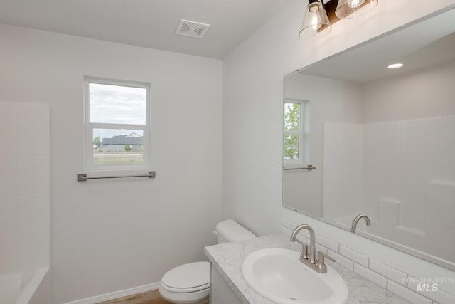 full bathroom featuring vanity, toilet, and visible vents