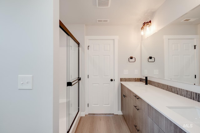 11129 Canvas St, Caldwell, ID 83605 - full bath featuring wood finished floors, a stall shower, and double vanity