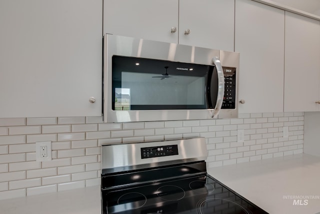 kitchen featuring stainless steel appliances, white cabinetry, ceiling fan, backsplash, and light countertops