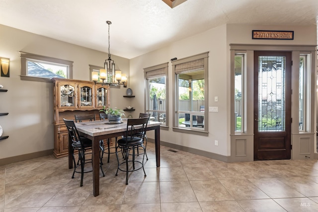 4763 S Skyridge Way, Boise, ID 83709 - dining area with a chandelier, baseboards, and light tile patterned floors