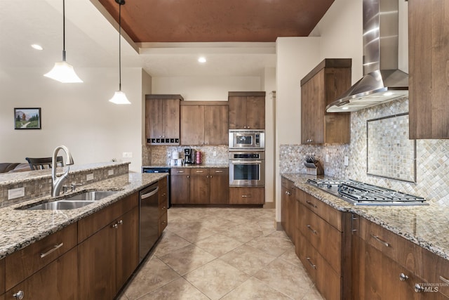 4763 S Skyridge Way, Boise, ID 83709 - kitchen with stainless steel appliances, wall chimney range hood, a sink, pendant lighting, and tasteful backsplash
