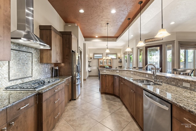 4763 S Skyridge Way, Boise, ID 83709 - kitchen featuring stainless steel appliances, a sink, wall chimney range hood, light tile patterned floors, and tasteful backsplash