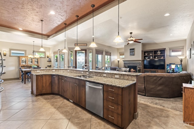 4763 S Skyridge Way, Boise, ID 83709 - kitchen featuring dishwasher, a sink, a fireplace, open floor plan, and a ceiling fan