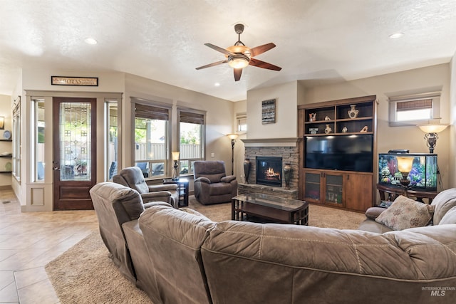 4763 S Skyridge Way, Boise, ID 83709 - living area with ceiling fan, a textured ceiling, recessed lighting, a fireplace, and light tile patterned flooring