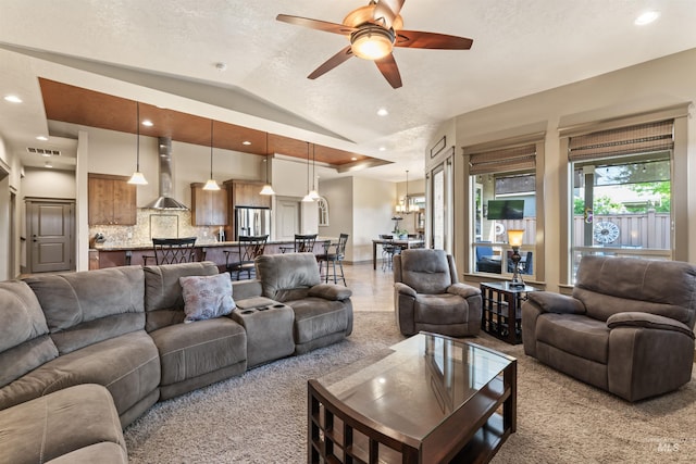 4763 S Skyridge Way, Boise, ID 83709 - living room with a ceiling fan, vaulted ceiling, recessed lighting, light carpet, and a textured ceiling