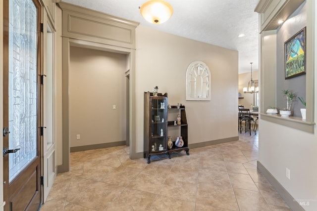 4763 S Skyridge Way, Boise, ID 83709 - hallway with a chandelier, light tile patterned floors, baseboards, a textured ceiling, and recessed lighting