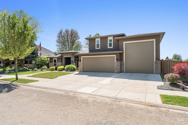 4763 S Skyridge Way, Boise, ID 83709 - view of front facade with stone siding, driveway, stucco siding, and a garage