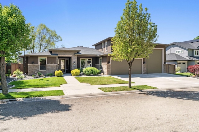 4763 S Skyridge Way, Boise, ID 83709 - prairie-style house with stone siding, concrete driveway, and an attached garage