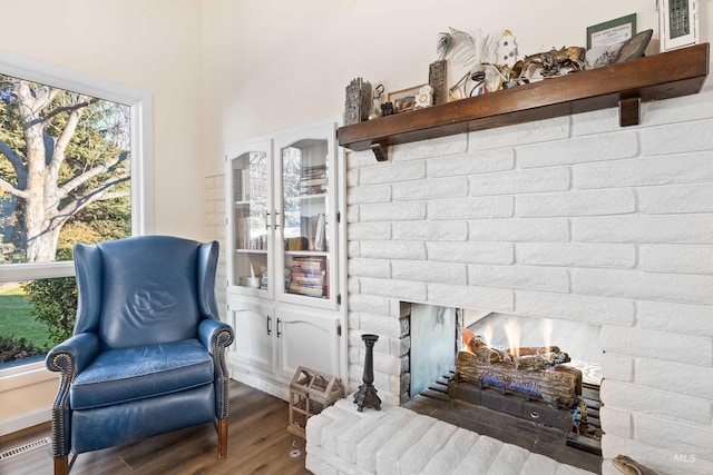 sitting room featuring wood-type flooring and a fireplace