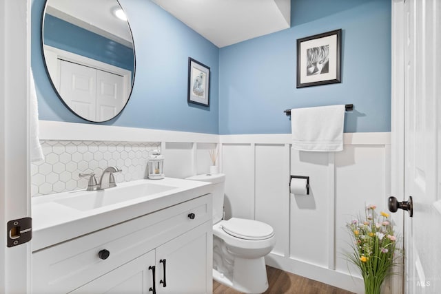 bathroom featuring hardwood / wood-style floors, vanity, and toilet