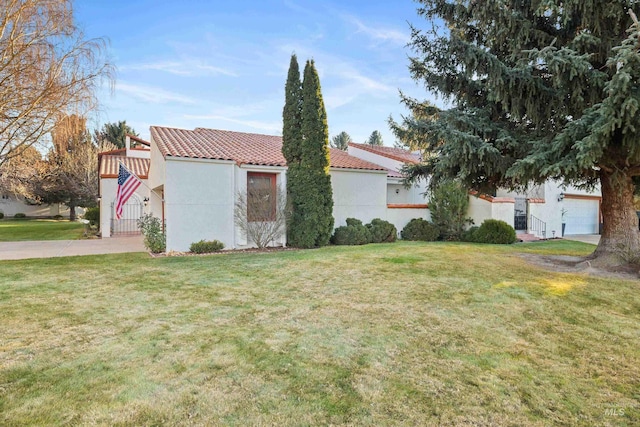 view of front of property with a front yard and a garage