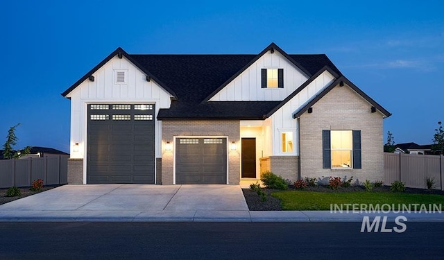 view of front of home with board and batten siding, driveway, and a garage