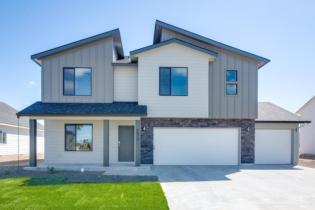 contemporary house with a porch, a garage, a shingled roof, concrete driveway, and board and batten siding