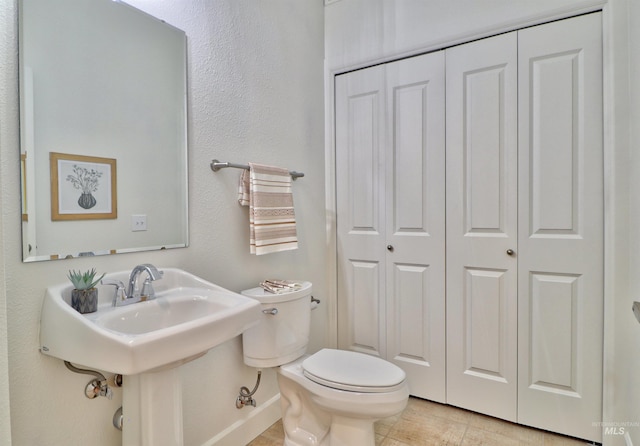 bathroom featuring tile patterned flooring and toilet