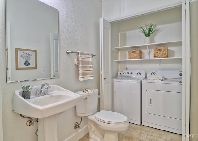 bathroom featuring tile patterned floors, toilet, and washer and clothes dryer