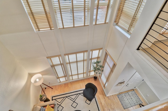 stairway featuring a high ceiling and hardwood / wood-style floors