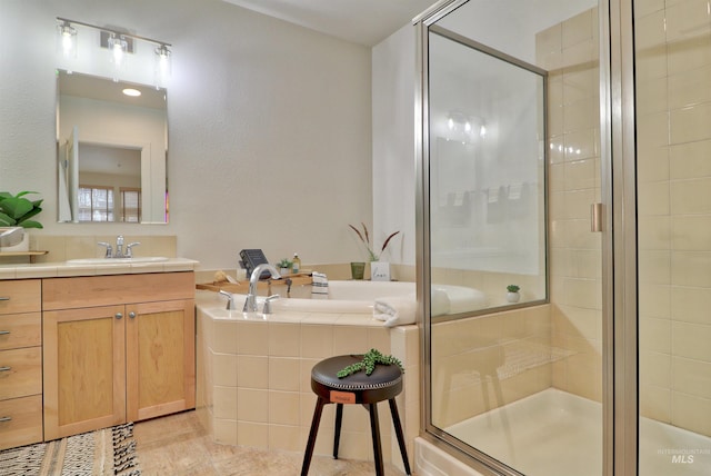 bathroom with tile patterned flooring, vanity, and shower with separate bathtub