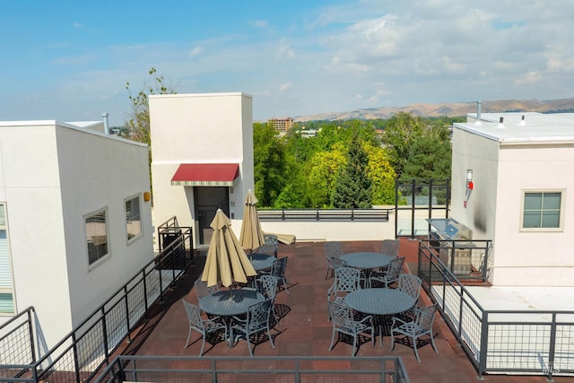 view of patio / terrace with a mountain view and a grill