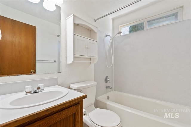 bathroom featuring toilet, shower / washtub combination, and vanity