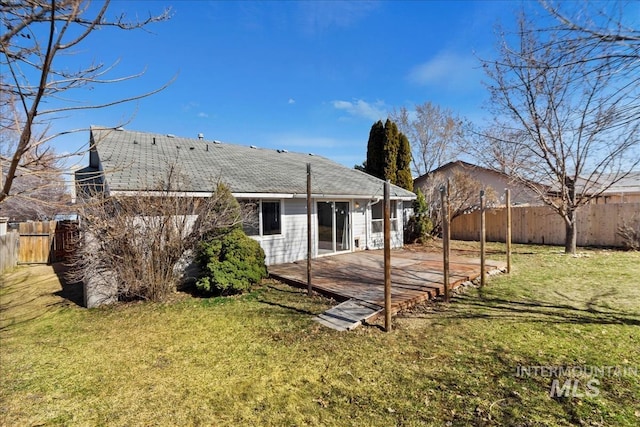 rear view of house with a patio area, a lawn, and fence