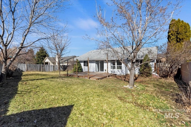 back of house featuring a yard, a patio, and a fenced backyard