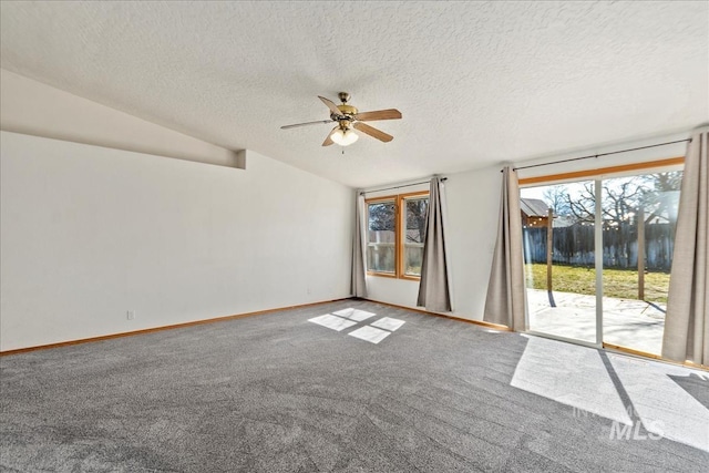 carpeted empty room featuring a textured ceiling, lofted ceiling, baseboards, and ceiling fan