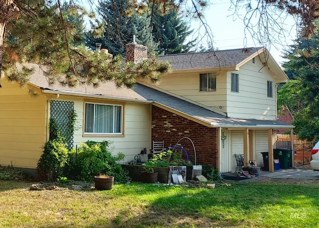 rear view of property with a yard