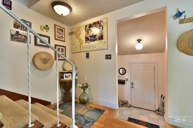 foyer featuring a textured ceiling