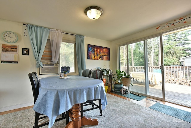 dining room featuring cooling unit and light hardwood / wood-style floors