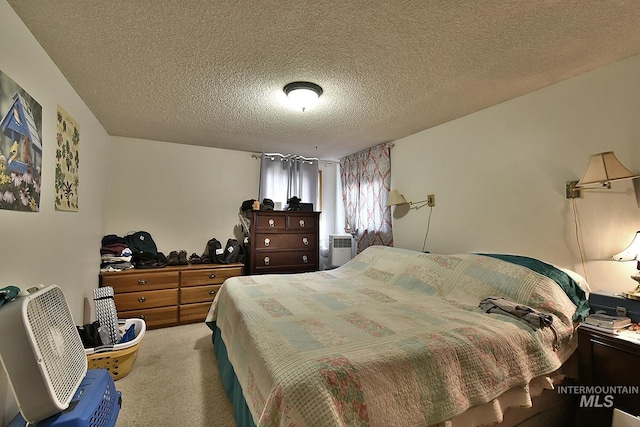 bedroom featuring carpet floors and a textured ceiling