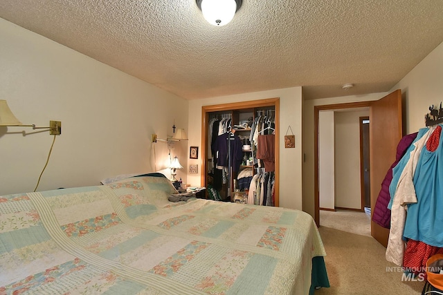 bedroom with light colored carpet, a textured ceiling, and a closet